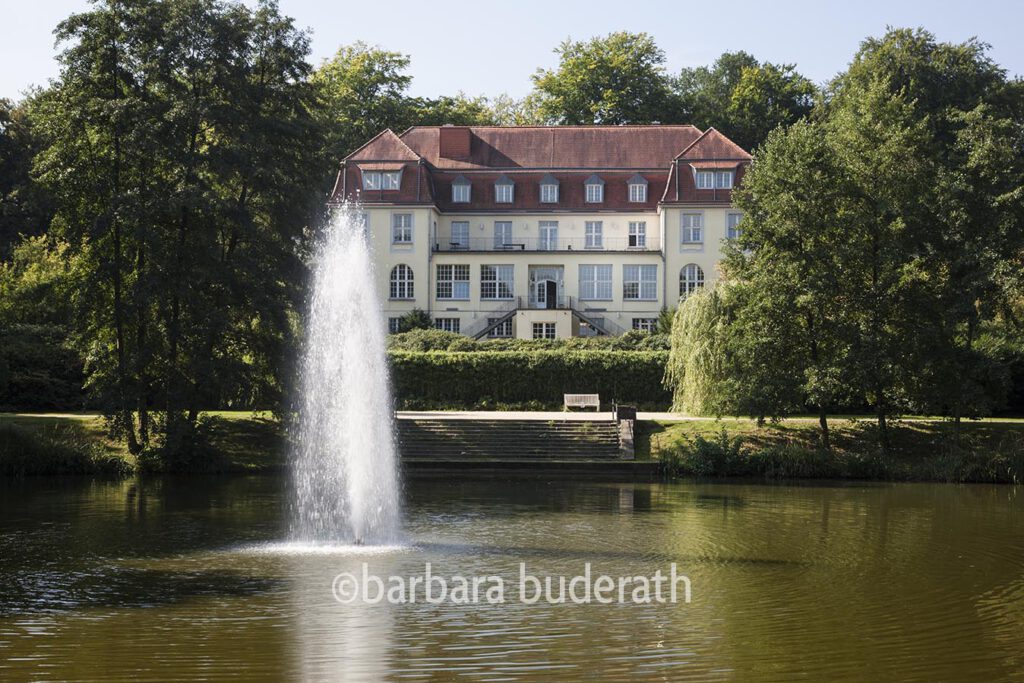 Theater an der Ruhr im ehemaligen Solebad Raffelberg in Mülheim an der Ruhr mit Teich des Kurparks im Vordergrund